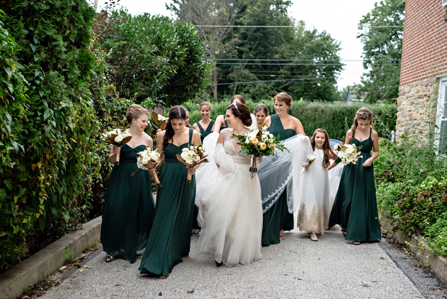 The bridesmaids walk the bride to the ceremony.